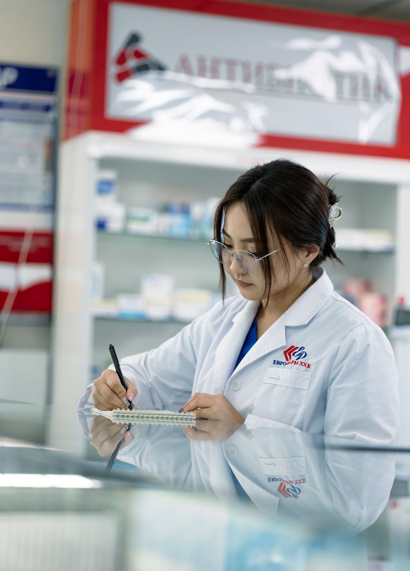 A pharmacist checking a prescription in the dispensary