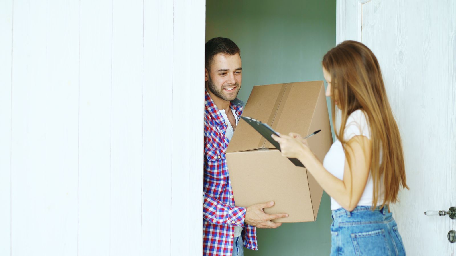 A parcel being handed over at a front door