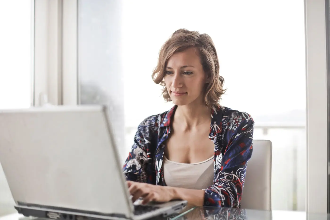 A woman working calmly on her laptop at home
