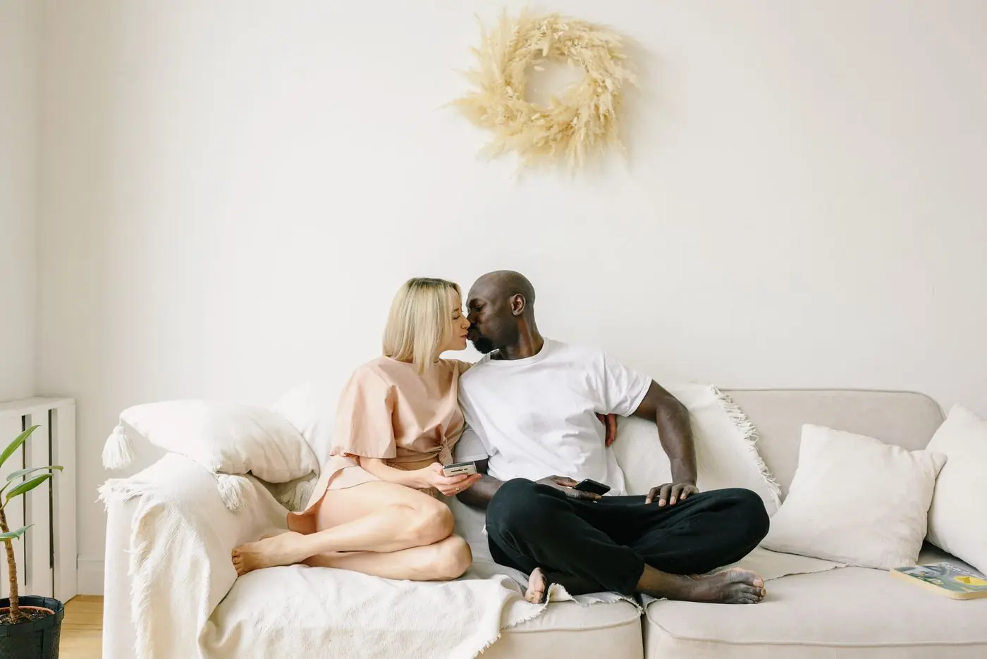 A happy couple relaxing together on their sofa at home
