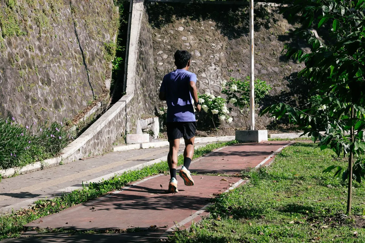 A woman out for a morning run along a park path